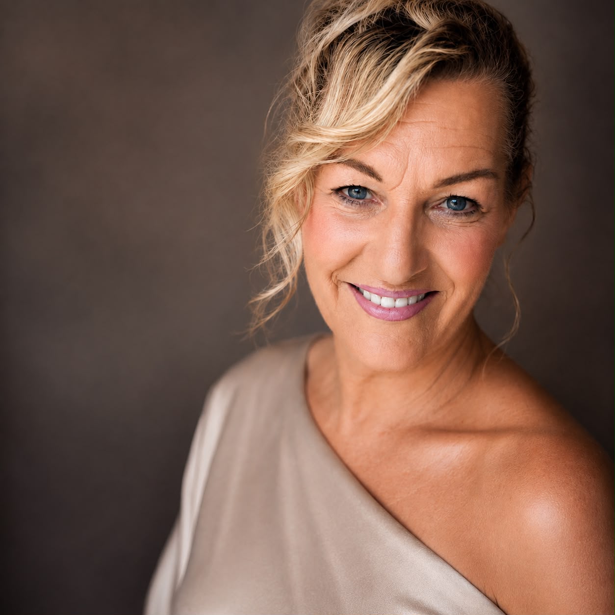 Mirjam Bikker in a studio portrait wearing a taupe one-shoulder top